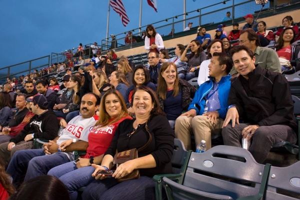 Group Smiling at Baseball Game